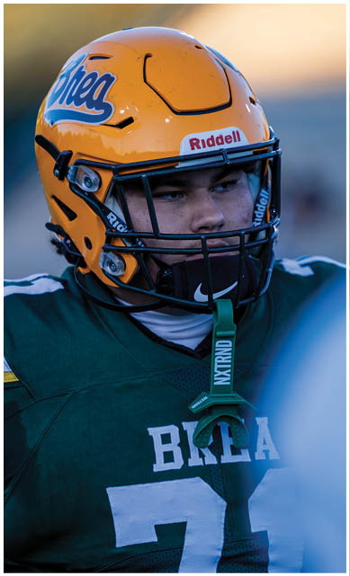 A football player wearing a blue jersey with the number 58 on it. Description generated by AI