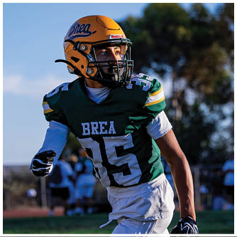 A football player running on the field. Description generated by AI
