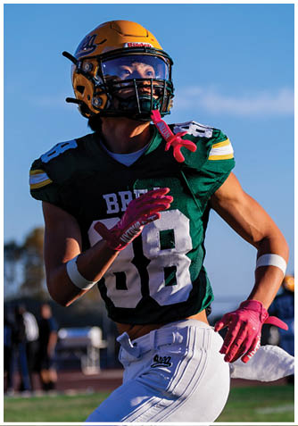 A football player wearing a blue jersey with the number 58 on it. Description generated by AI