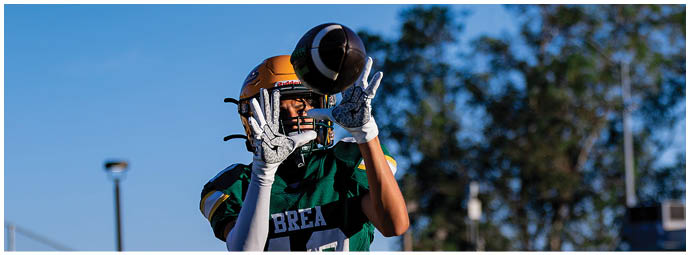 A football player is sliding on the ground. Description generated by AI