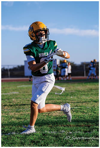 A football player running on the field. Description generated by AI