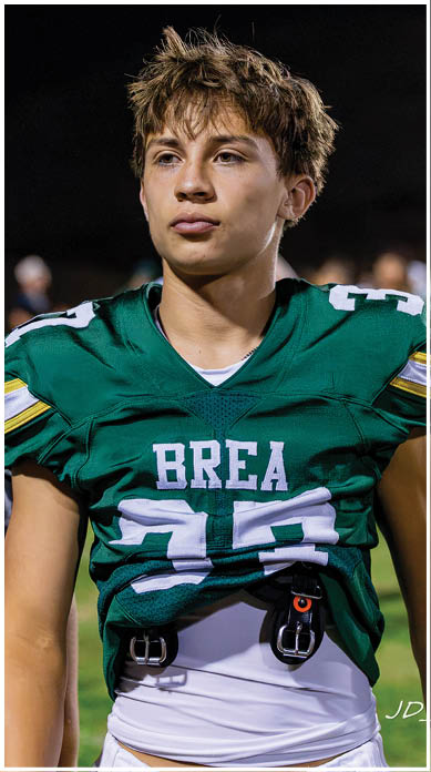 A football player running on the field. Description generated by AI