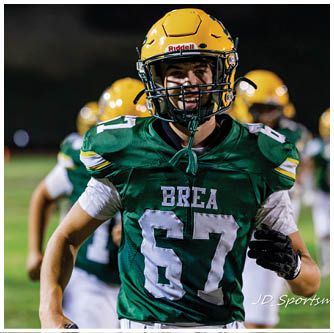 A football player running on the field. Description generated by AI