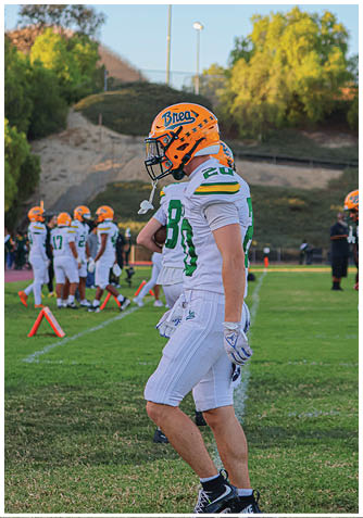A football player wearing a blue jersey with the number 58 on it. Description generated by AI