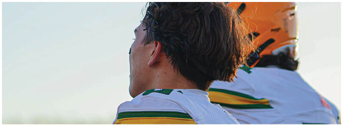 A football player is sliding on the ground. Description generated by AI