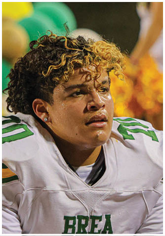 A football player wearing a blue jersey with the number 58 on it. Description generated by AI