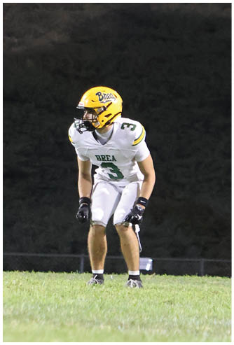 A football player running on the field. Description generated by AI