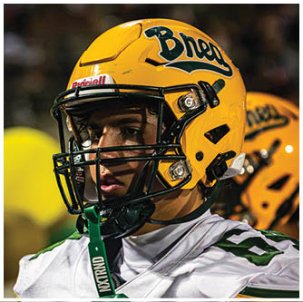 A football player running on the field. Description generated by AI