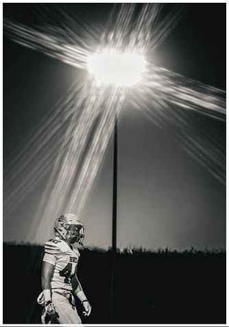 A football player wearing a blue jersey with the number 58 on it. Description generated by AI