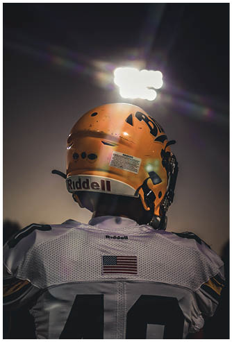A football player running on the field. Description generated by AI