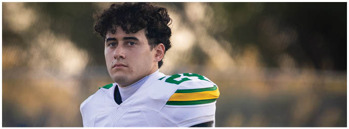 A football player is sliding on the ground. Description generated by AI