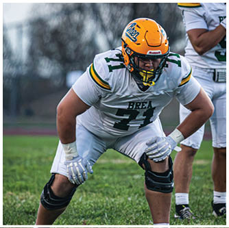 A football player running on the field. Description generated by AI