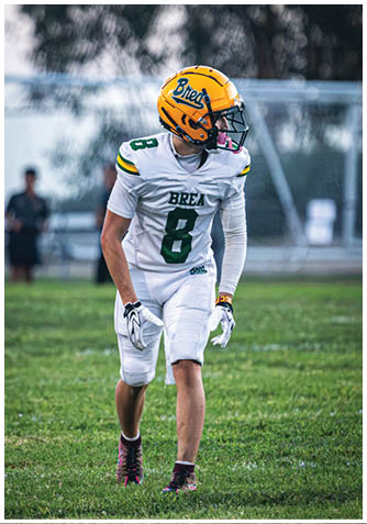 A football player wearing a blue jersey with the number 58 on it. Description generated by AI
