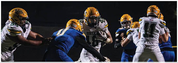 A group of football players on a field. Description generated by AI