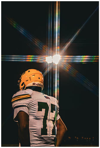 A football player running on the field. Description generated by AI