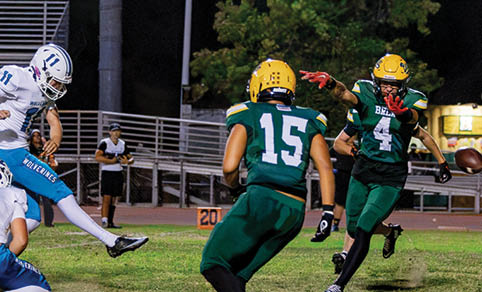 Two men wearing football uniforms are hugging each other on a field. AI generated content