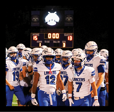 A scoreboard at a sports venue displays a wildcat logo, the word “KONOMOWOC," and a score showing zero for the home team and thirteen for the guest team. Description generated by AI
