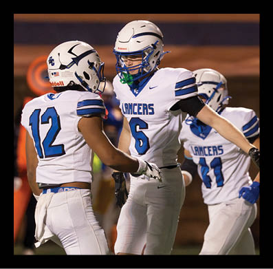 Two people wearing white athletic pants and gloves are standing close together, likely participating in a sports event. Description generated by AI