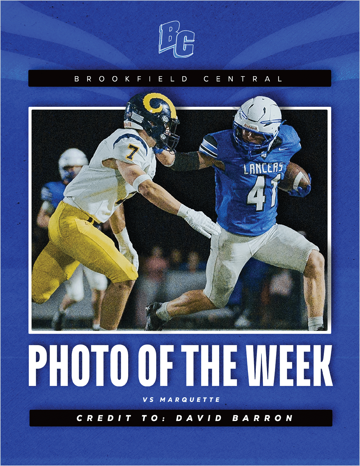 Two athletes in football uniforms are engaged in a play with one player in a blue jersey running while the other in a white and yellow uniform attempts to block or tackle. Description generated by AI
