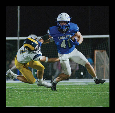 Two football players in action during a game, one wearing a blue jersey with “Lancers" and the number 41 running with the ball while the other in a white and yellow uniform attempts to block or tackle. Description generated by AI