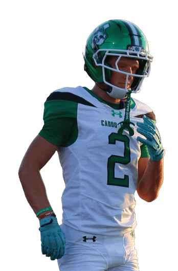A person wearing a green and white football uniform with the number 2 is standing on a field. Descripci n generada con IA