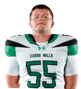 A person stands facing forward wearing a white and green football uniform with the number 55 and the words “Cedar Hills" on the jersey. Descripci n generada con IA