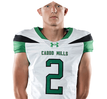 A person wearing a white and green football jersey with the number 2 and the text “Caddo Mills" on the front. Descripci n generada con IA