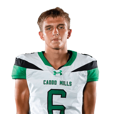 A person stands facing forward wearing a white and green sports uniform with the number six on the front against a white background. Descripci n generada con IA