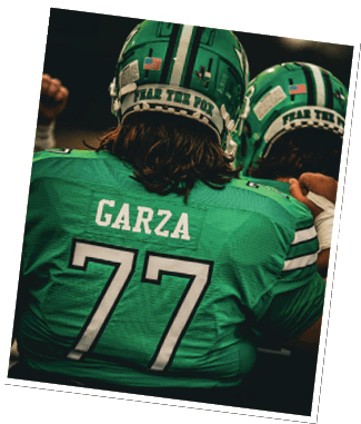 A person wearing a green football jersey with the name Garza and number 77 on the back is sitting with another person in similar attire. Descripci n generada con IA