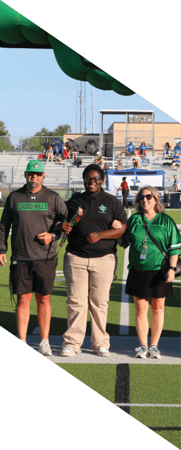 Tres personas con ropa deportiva verde caminan bajo un inflable grande con forma del estado de Texas que tiene un logo de un guila y una estrella negra.  Descripci n generada con IA