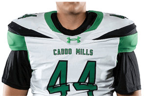 A person wearing a white and black sports jersey with the number 44 and green athletic pants stands with hands behind their back against a white background. Descripci n generada con IA
