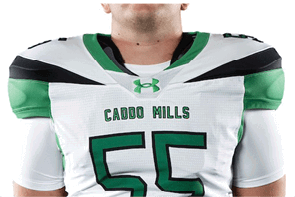 A person wearing a white and green football jersey with the number 55 and the words “Caddo Mills" on the front. Descripci n generada con IA
