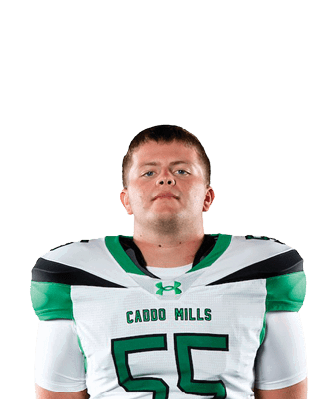 A person stands facing forward wearing a white and green football uniform with the number 55 and the words “Cedar Hills" on the jersey. Descripci n generada con IA