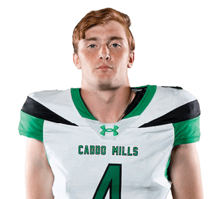 A person stands facing forward wearing a white and green football uniform with the number four on the jersey against a white background. Descripci n generada con IA