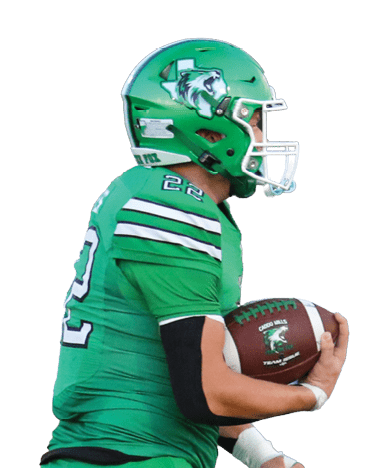 A person wearing a green football uniform and helmet is running on a field while holding a football. Descripci n generada con IA