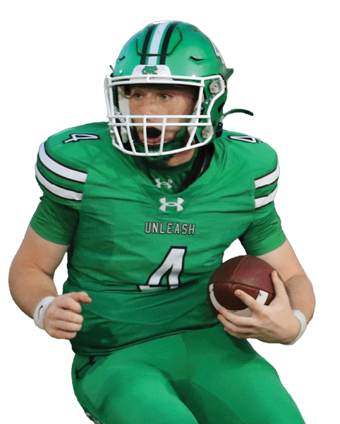 A person in a green football uniform is running with the ball while another person in a white and black uniform is chasing them on a football field. Descripci n generada con IA