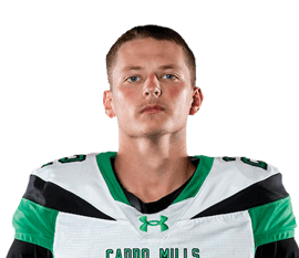 A person stands facing forward wearing a green and white football uniform with the number 22 and the words “Camp Hill" on the jersey. Descripci n generada con IA