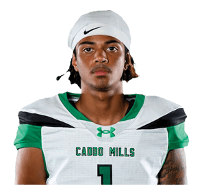 A person wearing a white sports jersey with the number one and green shorts stands with hands behind their back against a white background. Descripci n generada con IA