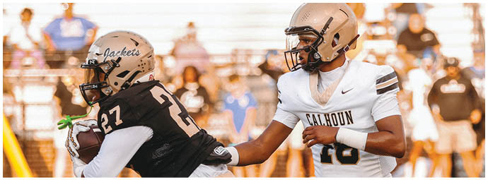 A football player wearing a blue and white uniform. Description generated by AI