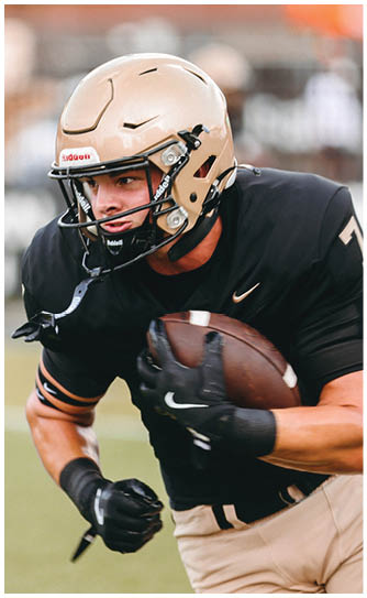 A football player catching a ball. Description generated by AI