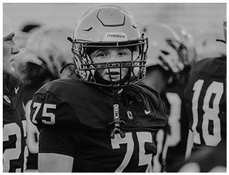 A group of football players on a field. Description generated by AI