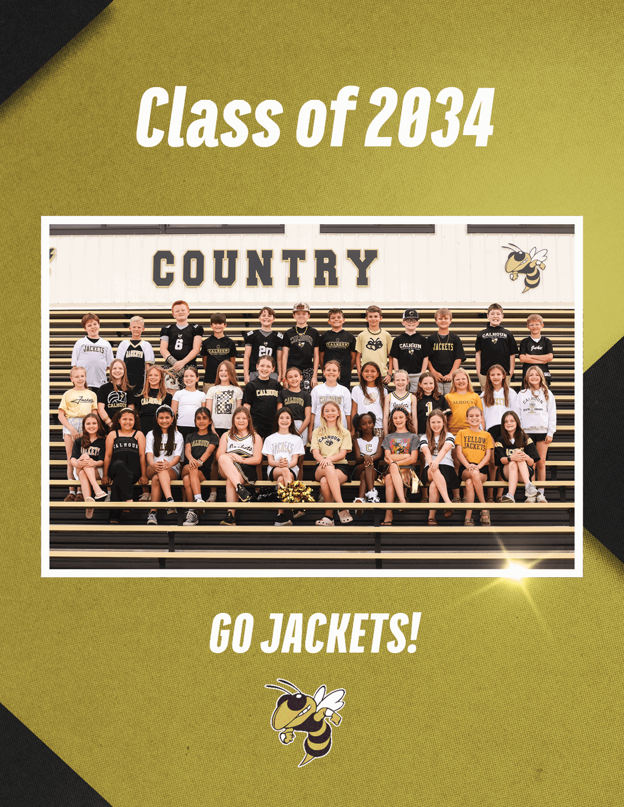 A group of children wearing school spirit clothing pose on bleachers under a sign that says “COUNTRY" with a yellow jacket mascot, with text above reading "Class of 2034" and below reading "GO JACKETS!" Description generated by AI