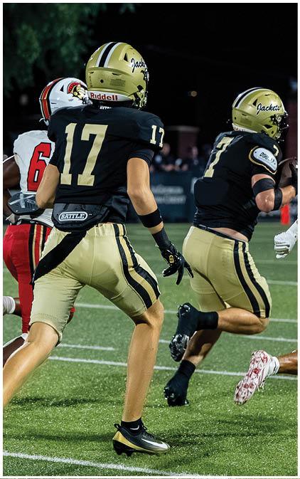 A football player running on the field. Description generated by AI