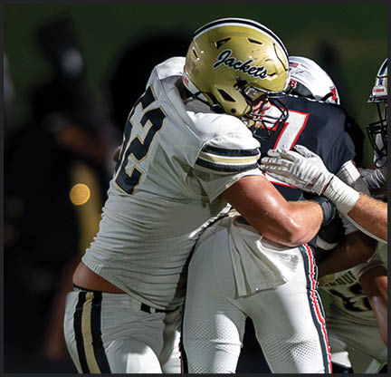 A football player is kicking a football on a field. Description generated by AI