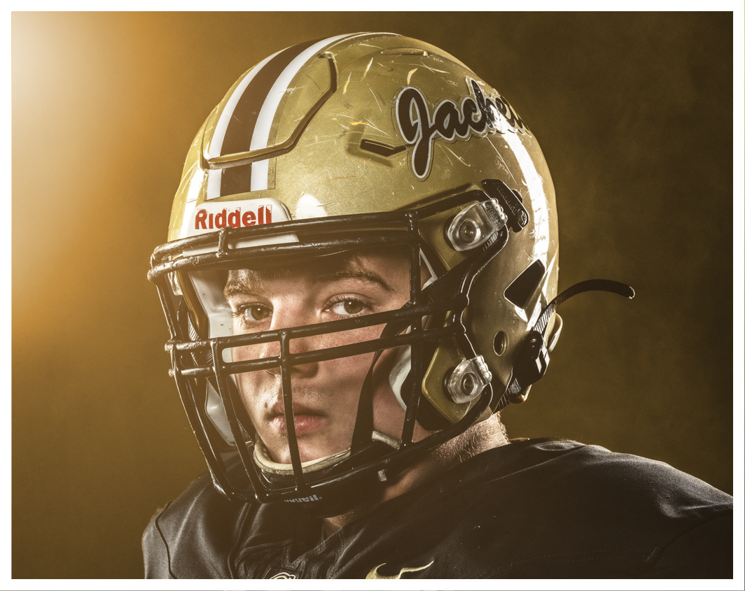 A football player wearing a black jersey. Description generated by AI