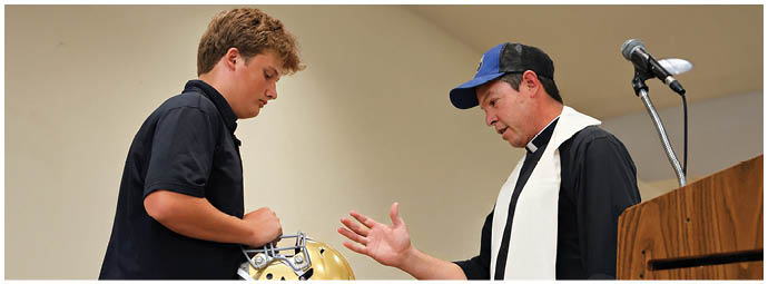 A football player wearing a blue and white uniform. Description generated by AI