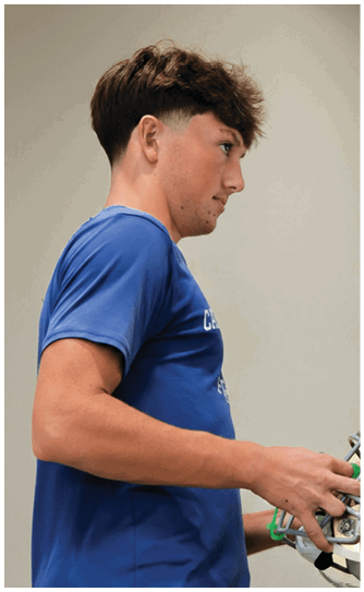 A football player catching a ball. Description generated by AI