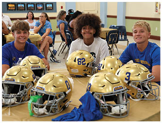 A group of football players on a field. Description generated by AI