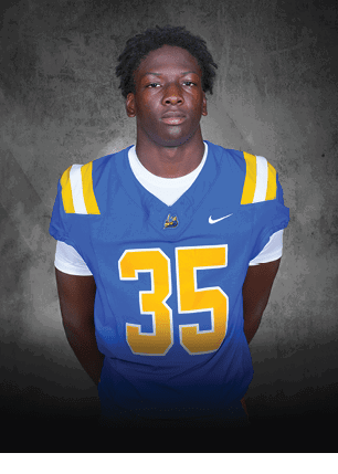 A young man wearing a white and black jersey with the number 14 on it. Description generated by AI