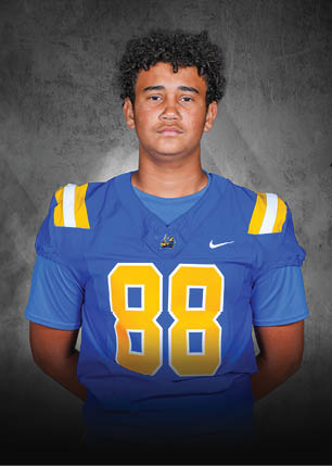 A young man wearing a white and black jersey with the number 14 on it. Description generated by AI